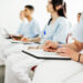 A group of nurses taking notes during a lecture at university.